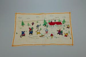 Image: Embroidered place mat with MacMillan-Moravian school and Inuit figures